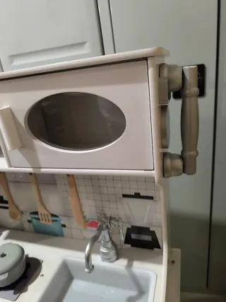 Cocinita de madera blanca con accesorios