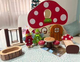 Casa de juguete de madera con muñecos