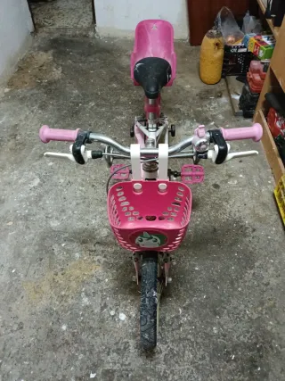 Bicicleta Btwin niña rosa con ruedines