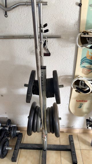 Gimnasio completo con barras y discos