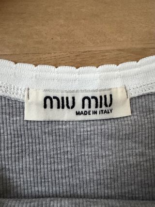 Top Miu gris con ribete blanco.