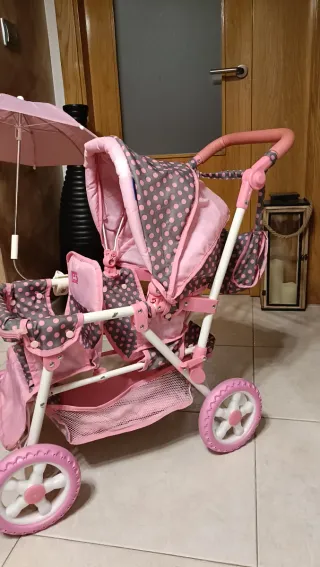 Cochecito gemelar para muñecas rosa