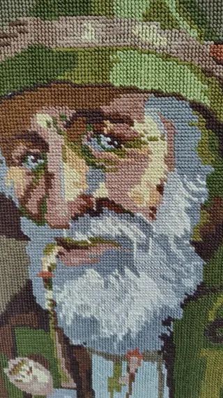 Cuadro a punto de anciano con sombrero