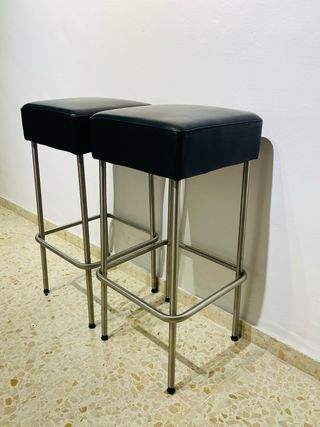Dos taburetes altos negros y plateados