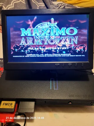 PS2 con pantalla, mando y juegos