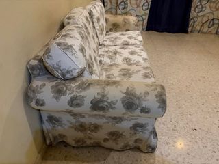 Sofá de tela beige y gris con estampado floral