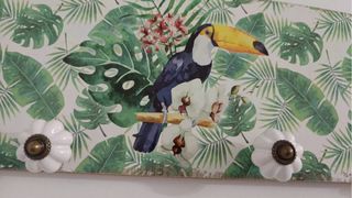 Perchero de pared con tucán y hojas tropicales