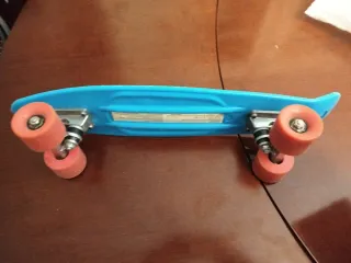 Patinete azul con ruedas naranjas