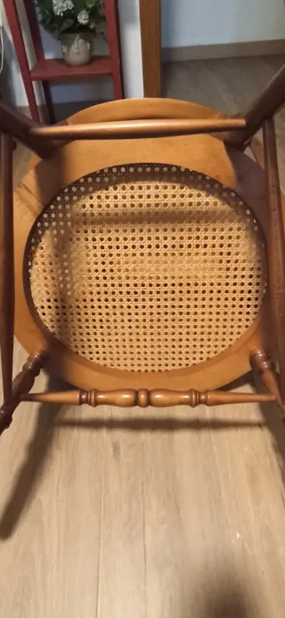 Mecedora pequeña de madera y ratán.