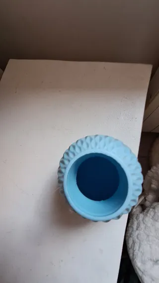 Jarrón azul con plumas decorativas