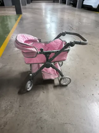 Cochecito de juguete rosa
