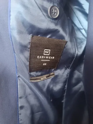 Traje de chaqueta azul con corbata roja, cinturón.