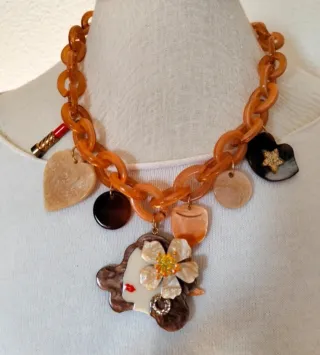 Collar con pendenti da donna e rossetto