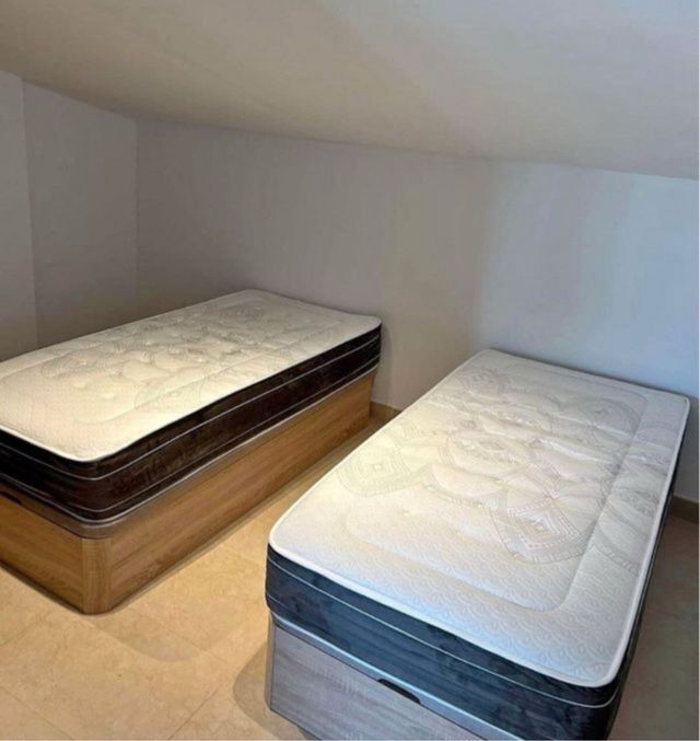 Base de cama blanca con colchón