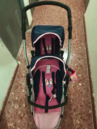 Carro gemelar de juguete rosa y azul