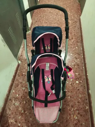 Carro gemelar de juguete rosa y azul