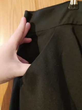 Pantalón negro con cremallera y tiras