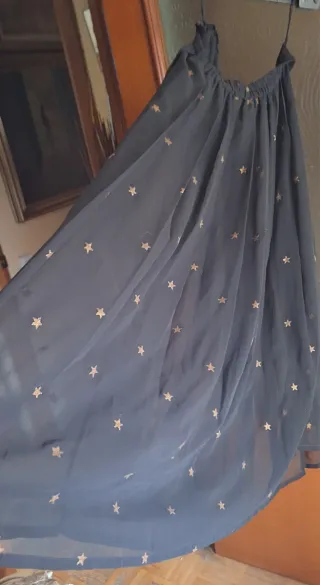Falda larga negra con estrellas doradas.