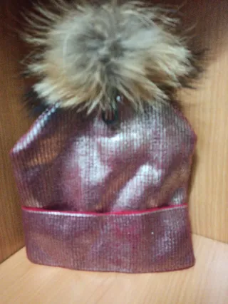 Gorro con pompón de pelo dorado con toques rojos