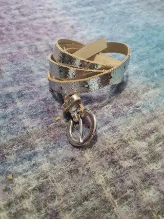 Cinturón plateado con hebilla redonda