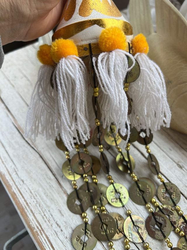 Colgante artesanal con monedas y borlas