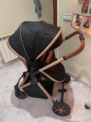 Carro de bebé negro y dorado