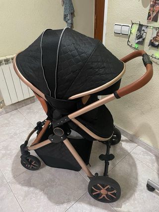 Carro de bebé negro y dorado