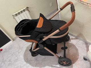 Carro de bebé negro y dorado