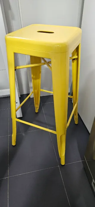 Taburetes de hierro amarillo y rosa.