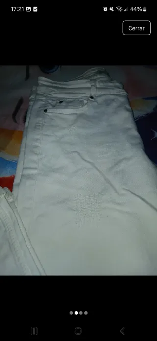 Pantalón vaquero blanco desgastado.