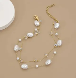 Pulsera dorada con perlas y cristales