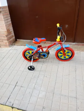 Bicicleta infantil roja con ruedines
