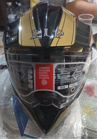 Casco de moto dorado y negro