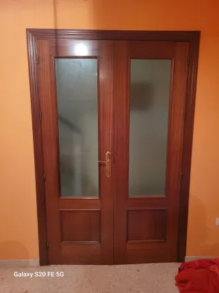 Puerta doble de madera con cristal
