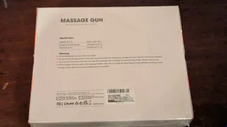 Pistola de masaje nueva, sin usar, aún en su caja