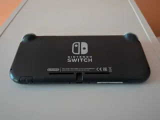 Nintendo Switch Lite Gris, funda, cargador origina
