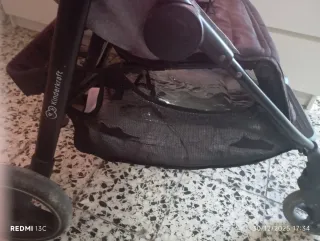 Carro de bebé con saco y plástico de lluvia