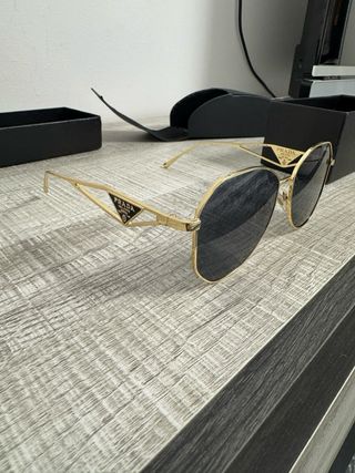 Occhiali da sole donna Prada dorati e neri