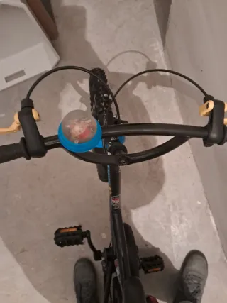 Bicicleta infantil negra con timbre azul