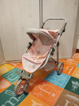 Carro de muñecas rosa con estrellas