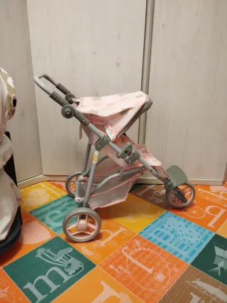 Carro de muñecas rosa con estrellas