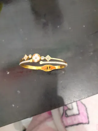 Pulsera de acero dorada con diseño floral