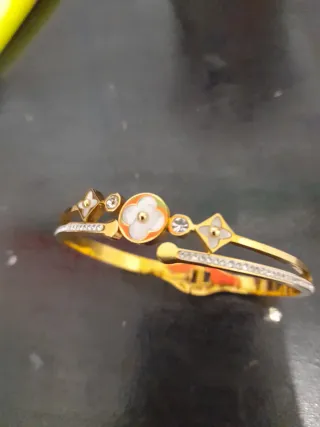 Pulsera de acero dorada con diseño floral