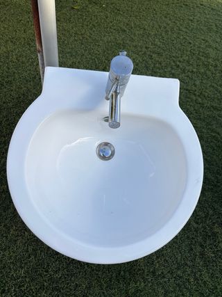 Lavabo de cerámica con grifo metálico
