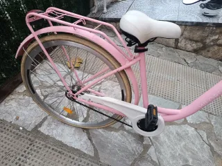 Bicicleta rosa y blanca con cesta