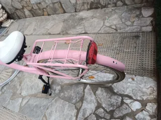 Bicicleta rosa y blanca con cesta