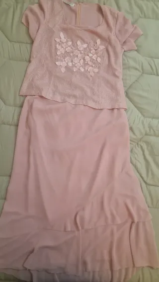 Traje rosa empolvado con top y falda.