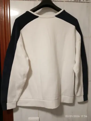 Sudadera blanca con detalles azul marino.