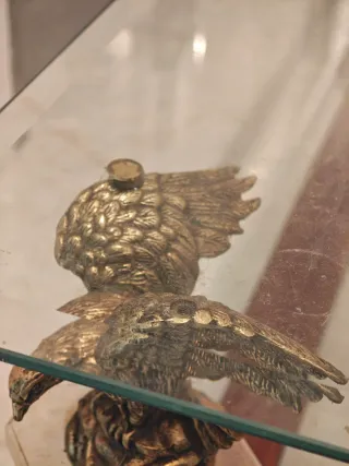 Antigua mesa de cristal con águilas.