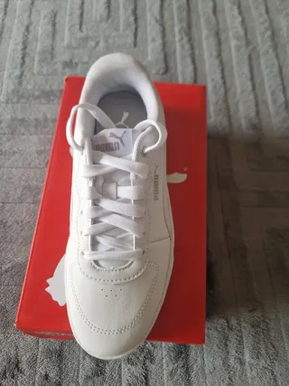 Zapatillas Puma Blancas con tono plateado atrás